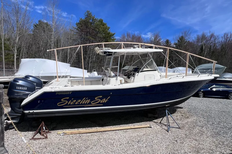 Slide: The Image of 2001 Pursuit 3070 Center Console boat with Yamaha engines, parked outdoors. - 55