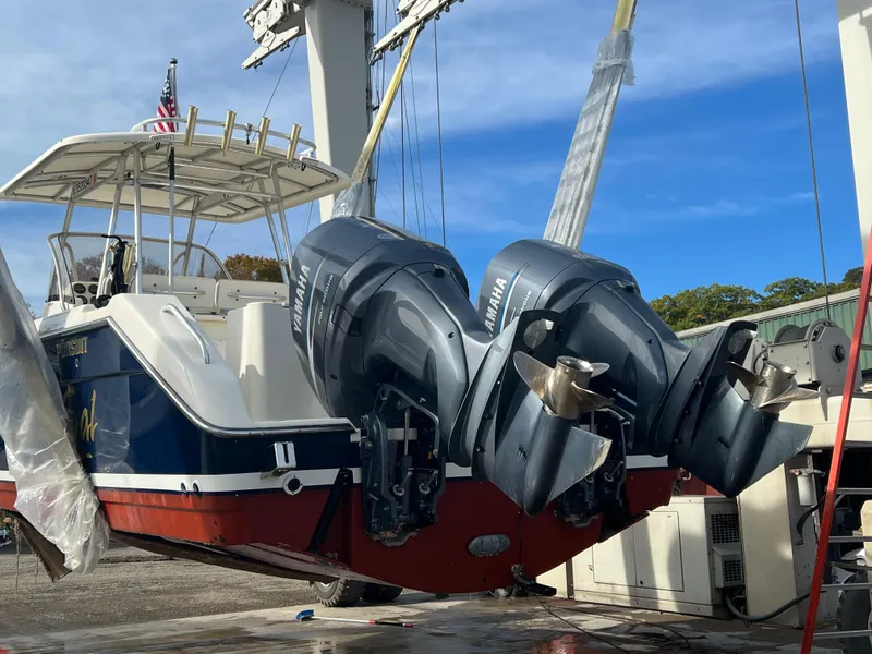 Slide: The Image of 2001 Pursuit 3070 Center Console boat with dual Yamaha outboard engines on a lift. - 6
