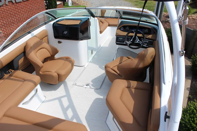 Slide: The Image of 2025 Four Winns HD3 OB boat interior with tan seating and modern dashboard. - 11