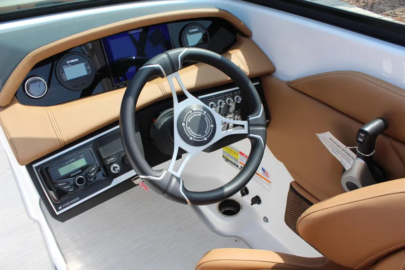 Slide: The Image of 2025 Four Winns HD3 OB boat dashboard with steering wheel and control panel. - 14