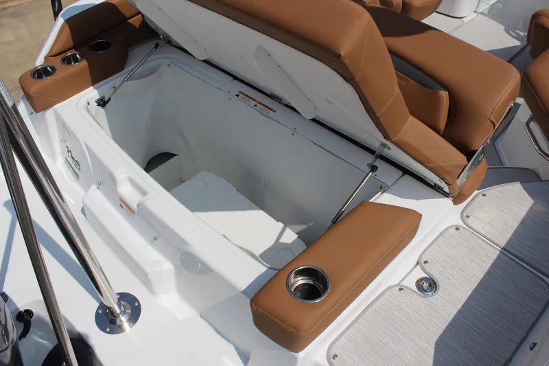 Slide: The Image of 2025 Four Winns HD3 OB boat with open storage compartment and brown seating. - 15