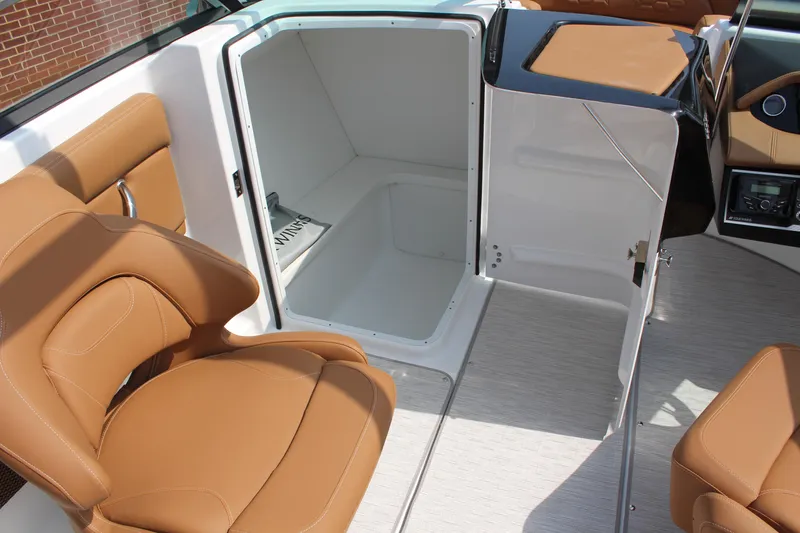Slide: The Image of 2025 Four Winns HD3 OB boat interior with tan seating and storage compartment. - 16