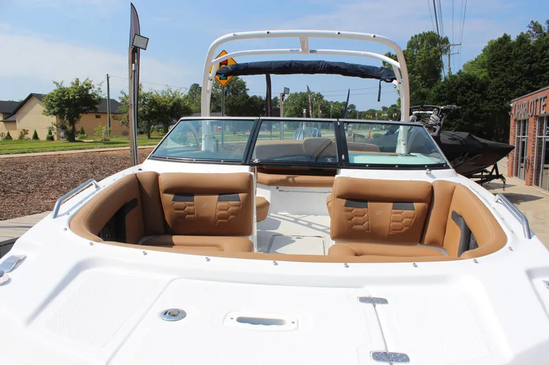 Slide: The Image of 2025 Four Winns HD3 OB boat with tan seating and sleek design. - 17