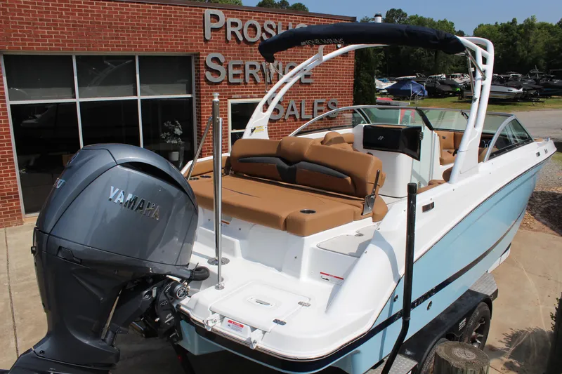 Slide: The Image of 2025 Four Winns HD3 OB boat with Yamaha engine at dealership. - 4