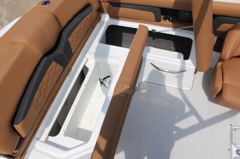 Slide: The Image of 2025 Four Winns HD3 OB boat interior with tan seating and storage compartments. - 5