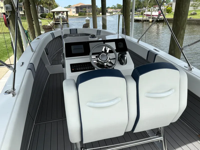 Slide: The Image of Modern 2023 Action 25 boat interior with sleek steering console and comfortable seating. - 2