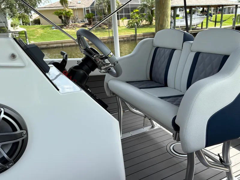Slide: The Image of Luxury boat interior with modern steering and cushioned seating, Action 25 model, 2023. - 6