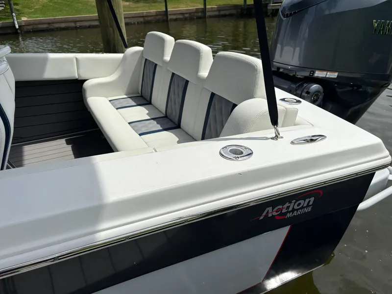 Slide: The Image of 2023 Action 25 boat with white seating and Yamaha outboard motor. - 3