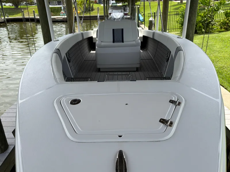 Slide: The Image of Modern Action 25 boat docked, showcasing sleek design and spacious interior, 2023 model. - 7