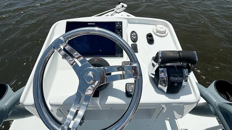 Slide: The Image of 2020 Yellowfin 26 Hybrid boat dashboard with steering wheel and controls. - 6