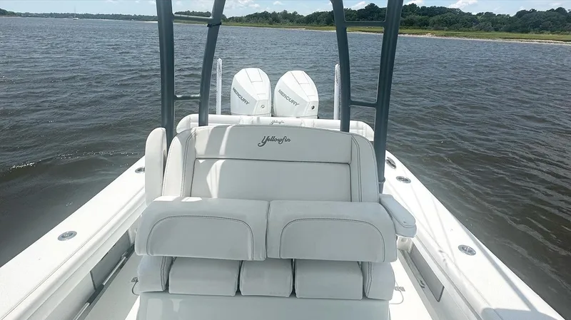 Slide: The Image of 2020 Yellowfin 26 Hybrid boat with dual Mercury engines on a calm waterway. - 9