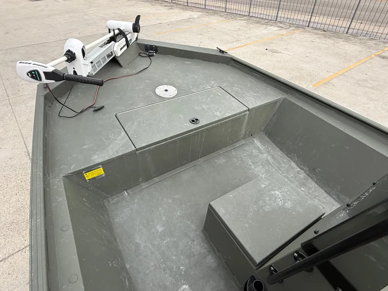 Slide: The Image of 2015 Alweld 1870 boat interior with trolling motor, parked on concrete. - 10