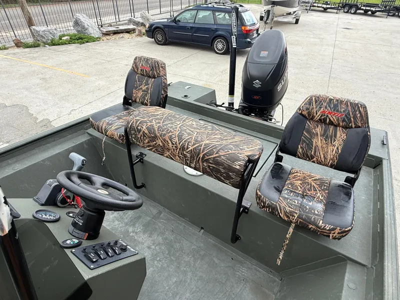 Slide: The Image of 2015 Alweld 1870 boat interior with camo seats and Suzuki outboard motor. - 11