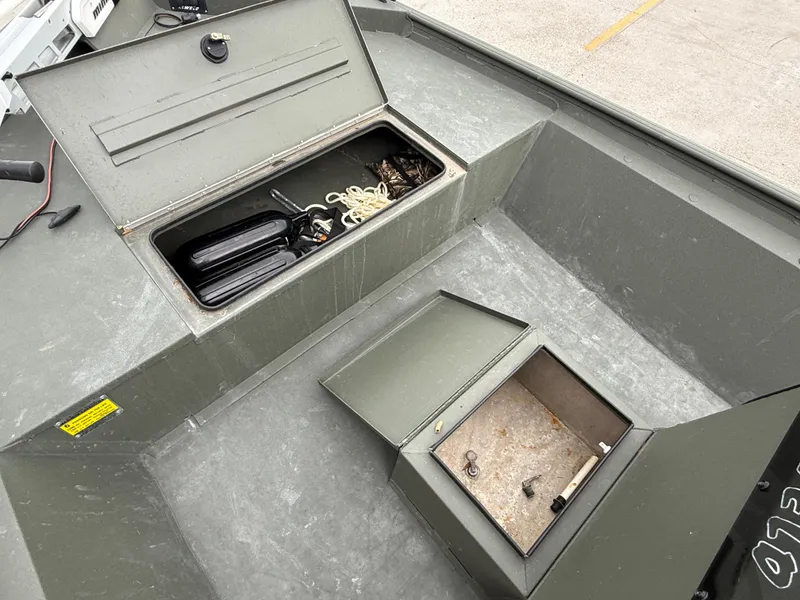 Slide: The Image of 2015 Alweld 1870 boat interior with open storage compartments and equipment. - 12