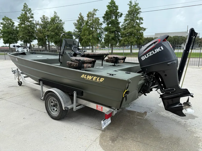 Slide: The Image of 2015 Alweld 1870 boat with Suzuki outboard motor on trailer. - 4