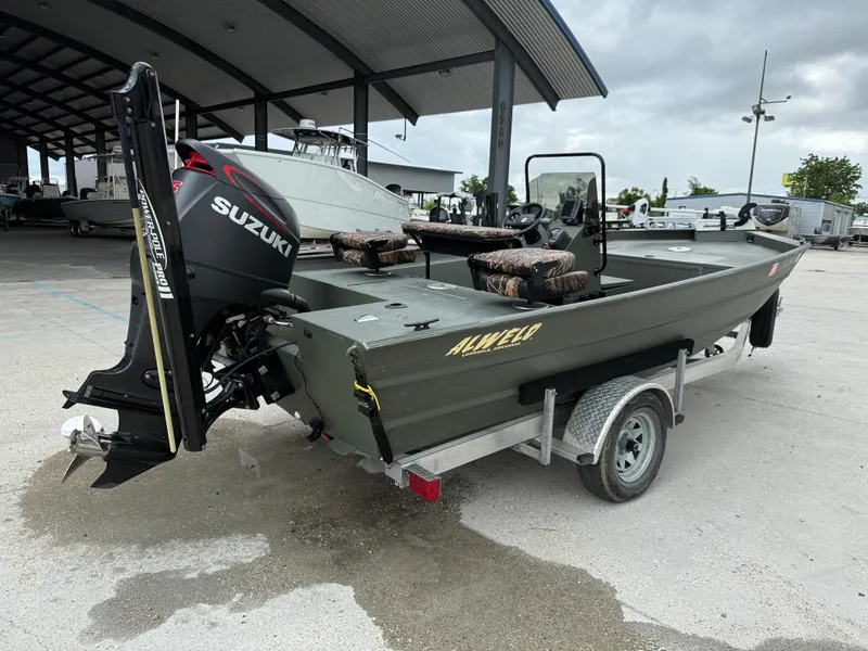 Slide: The Image of 2015 Alweld 1870 boat with Suzuki motor on trailer, parked under a shelter. - 6