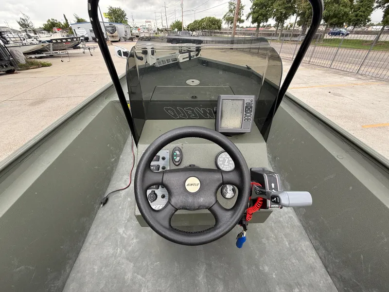 Slide: The Image of 2015 Alweld 1870 boat dashboard with steering wheel and navigation equipment. - 8