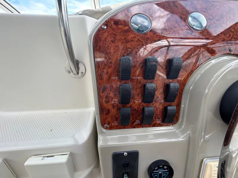Slide: The Image of Control panel of a 1998 Maxum 2800 SCR boat with switches and gauges. - 14