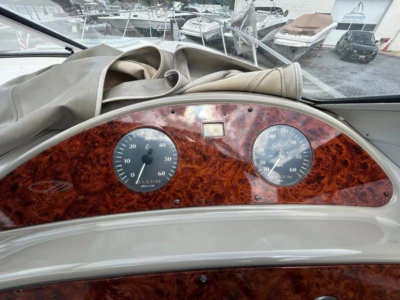 Slide: The Image of Dashboard of a 1998 Maxum 2800 SCR boat with gauges and cover. - 16