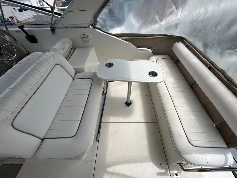 Slide: The Image of 1998 Maxum 2800 SCR boat interior with white seating and table. - 18