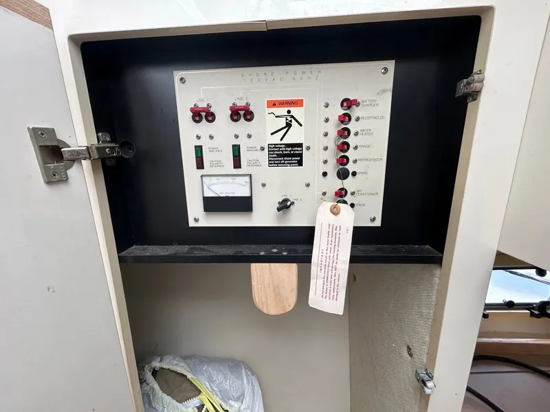 Slide: The Image of Electrical panel inside a 1998 Maxum 2800 SCR boat, featuring switches and warning labels. - 19