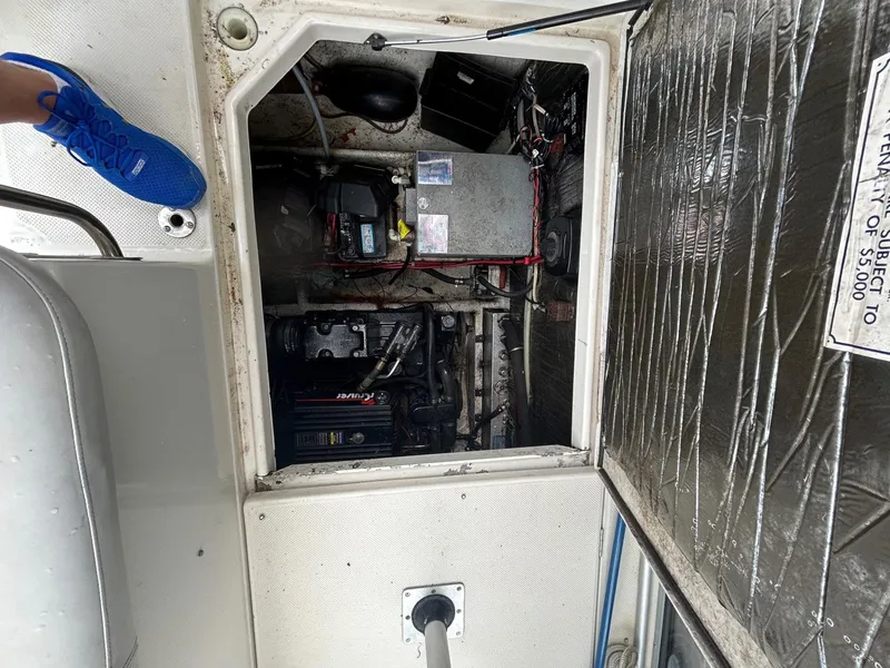 Slide: The Image of Engine compartment of a 1998 Maxum 2800 SCR boat, showing mechanical components and wiring. - 20