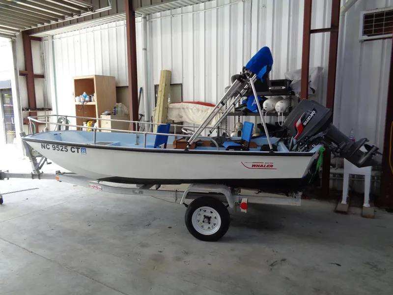 Slide: The Image of 1964 Boston Whaler 13 Sport boat on trailer in a garage setting. - 1