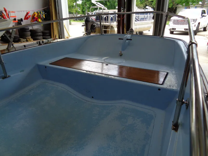 Slide: The Image of 1964 Boston Whaler 13 Sport boat interior with blue hull and wooden seat. - 12