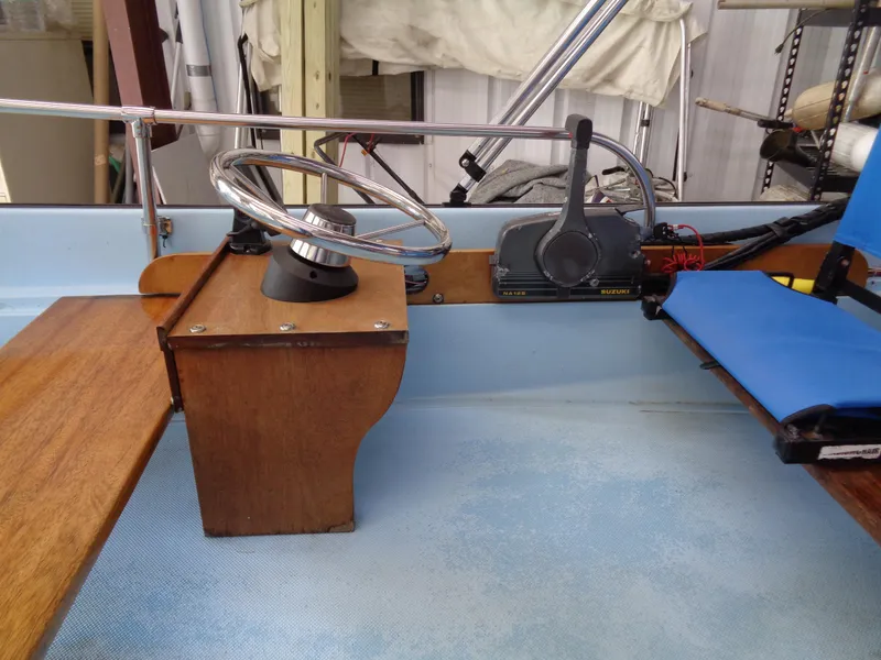 Slide: The Image of 1964 Boston Whaler 13 Sport interior with steering wheel and controls. - 15