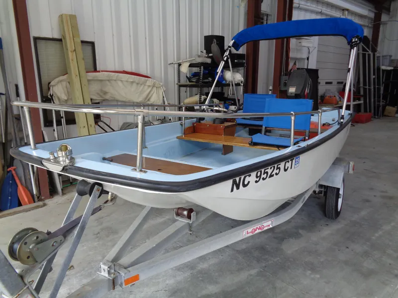 Slide: The Image of 1964 Boston Whaler 13 Sport boat on trailer in a garage setting. - 17