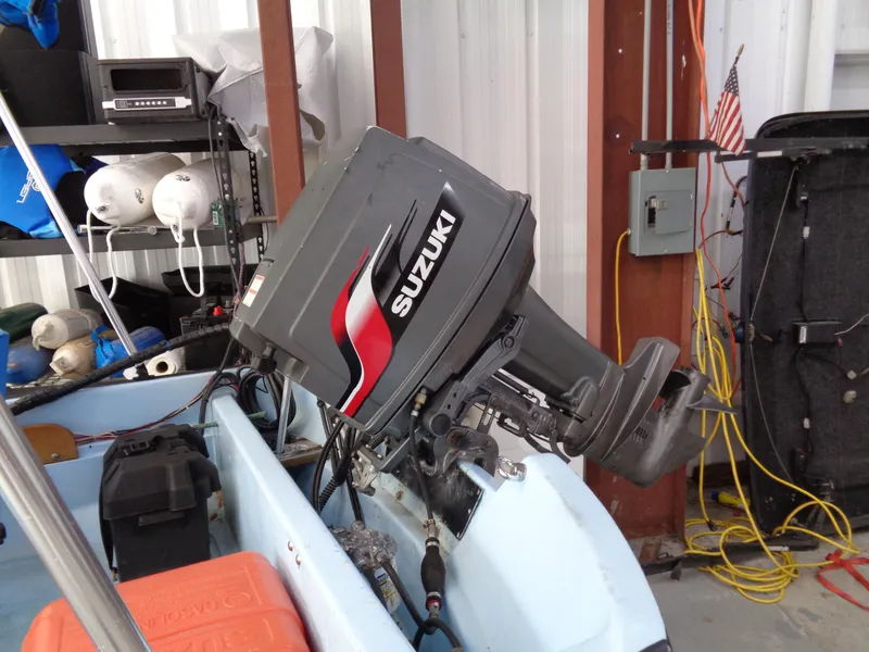 Slide: The Image of 1964 Boston Whaler 13 Sport with Suzuki outboard motor in a garage setting. - 4