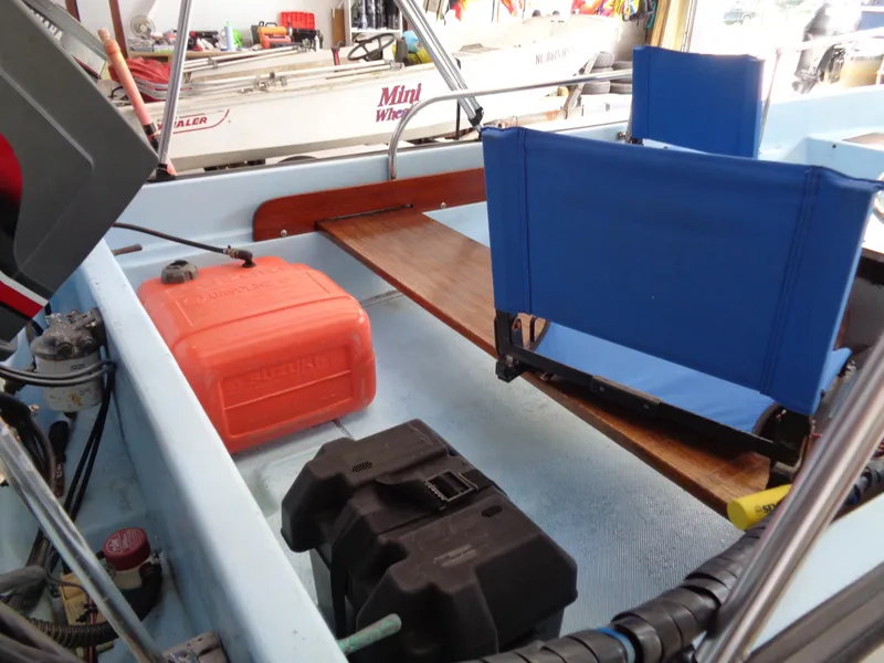 Slide: The Image of 1964 Boston Whaler 13 Sport interior with blue seats and orange fuel tank. - 5