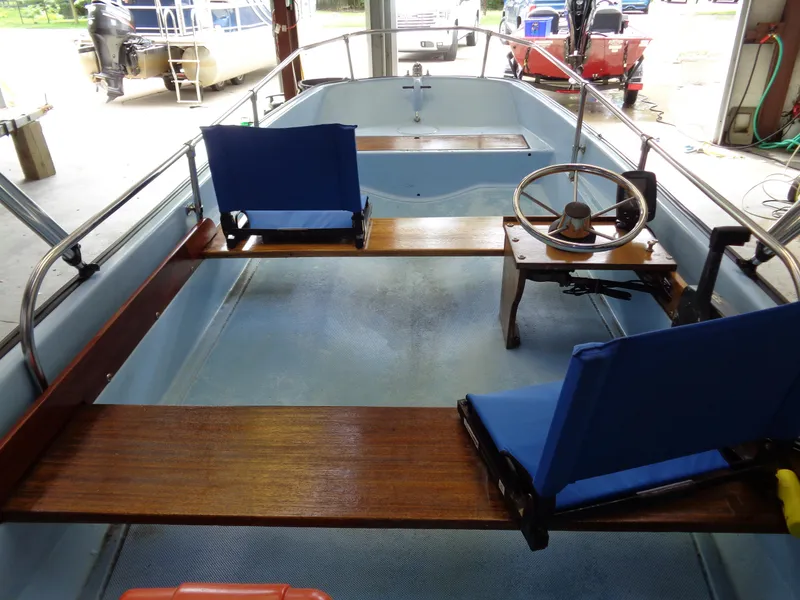 Slide: The Image of 1964 Boston Whaler 13 Sport boat interior with wooden seats and steering wheel. - 6