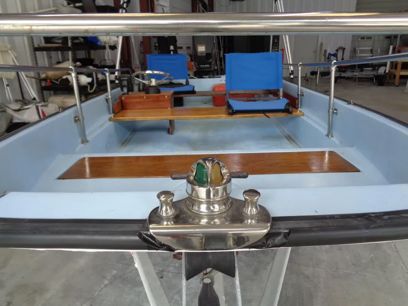 Slide: The Image of 1964 Boston Whaler 13 Sport interior with blue seats and wooden accents. - 7
