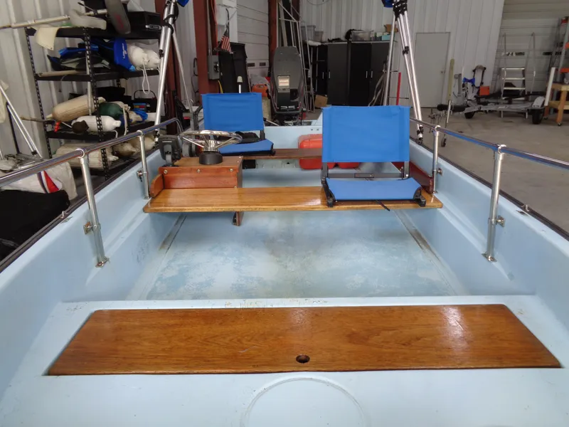 Slide: The Image of 1964 Boston Whaler 13 Sport boat interior with blue seats and wooden accents. - 8