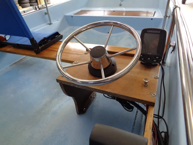 Slide: The Image of 1964 Boston Whaler 13 Sport boat interior with steering wheel and navigation equipment. - 9