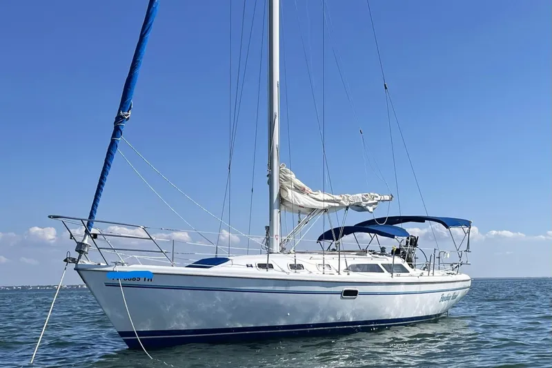 The Image of 1998 Catalina 34 MkII sailboat on calm water under clear blue sky. - 0