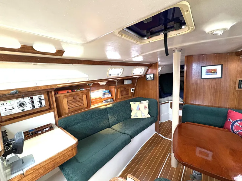 Slide: The Image of Interior of 1998 Catalina 34 MkII sailboat with green seating and wooden accents. - 11
