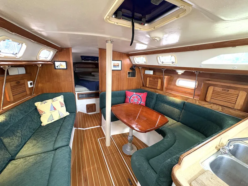 Slide: The Image of Interior of a 1998 Catalina 34 MkII sailboat with cozy seating and wooden accents. - 13