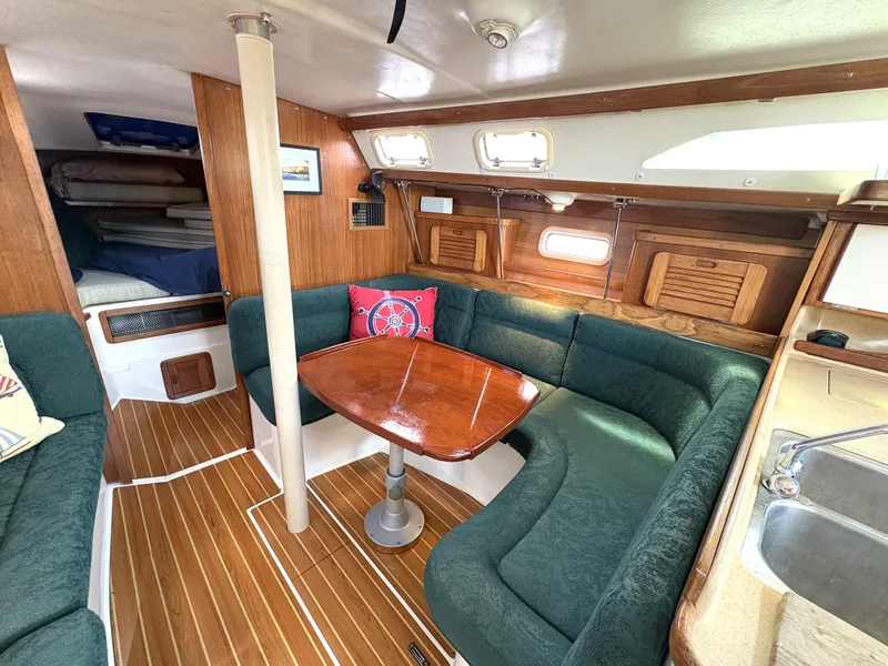 Slide: The Image of Interior of 1998 Catalina 34 MkII sailboat with cozy seating and wooden table. - 16