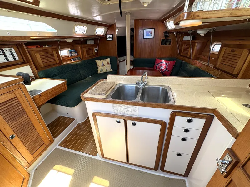 Slide: The Image of Interior of 1998 Catalina 34 MkII sailboat with cozy seating and wooden cabinetry. - 17