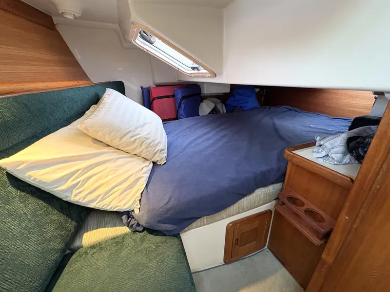 Slide: The Image of Cozy cabin interior of a 1998 Catalina 34 MkII sailboat with bed and storage. - 21