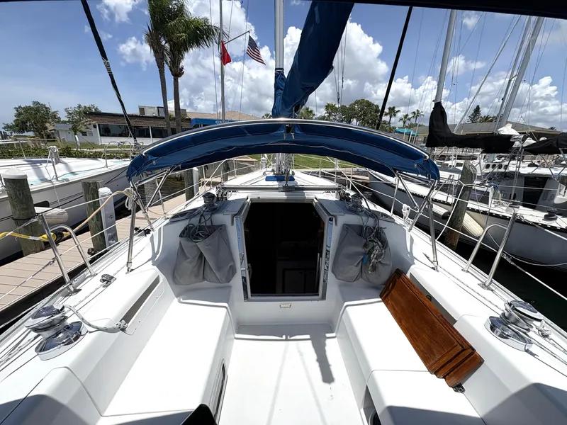 Slide: The Image of 1998 Catalina 34 MkII sailboat cockpit with blue canopy, docked at marina. - 8