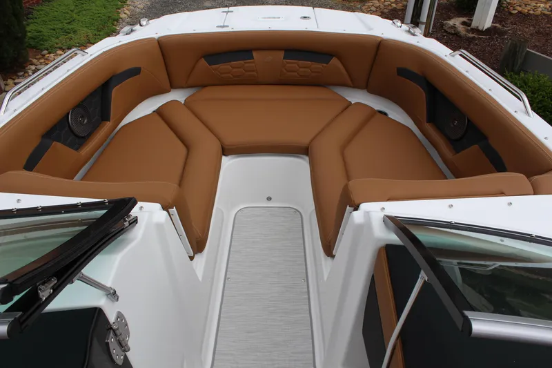 Slide: The Image of 2025 Four Winns HD3 OB boat interior with brown cushioned seating and sleek design. - 11