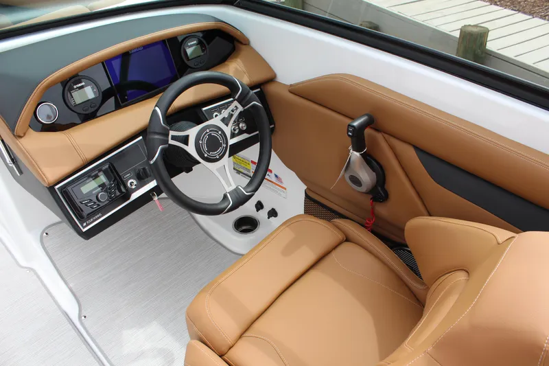 Slide: The Image of 2025 Four Winns HD3 OB boat interior with tan leather seats and modern dashboard. - 13