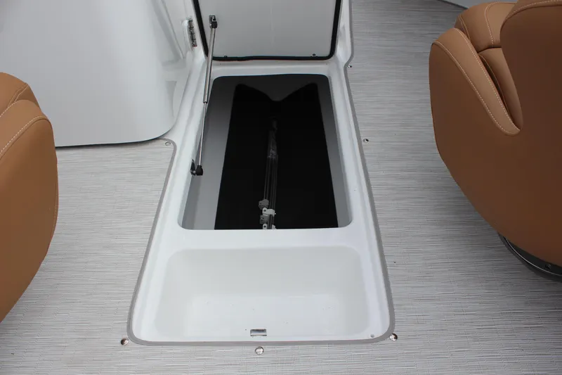 Slide: The Image of 2025 Four Winns HD3 OB boat storage compartment with open hatch and tan seating. - 15