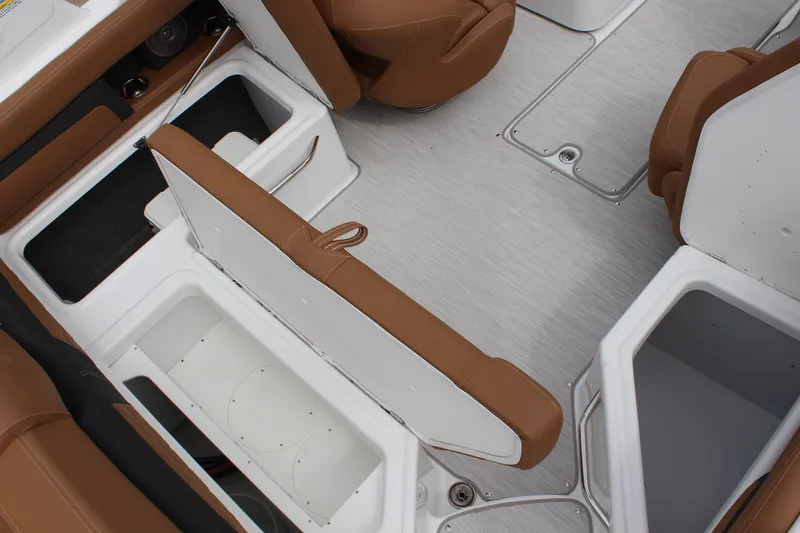 Slide: The Image of 2025 Four Winns HD3 OB boat interior with brown seating and open storage compartments. - 17