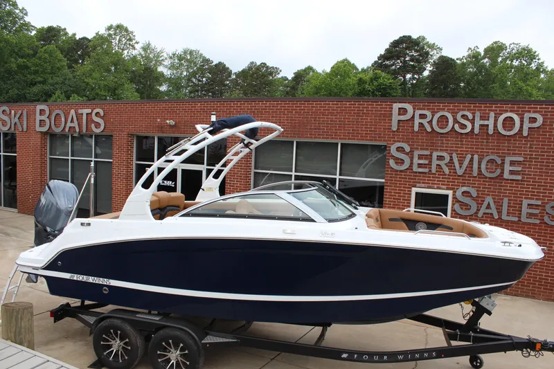 Slide: The Image of 2025 Four Winns HD3 OB boat on trailer outside dealership. - 2