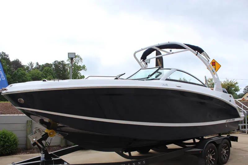 Slide: The Image of 2025 Four Winns HD3 OB boat on trailer, sleek design, outdoor display. - 6