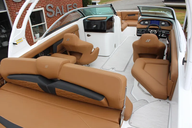 Slide: The Image of 2025 Four Winns HD3 OB boat interior with tan leather seating and modern dashboard. - 8
